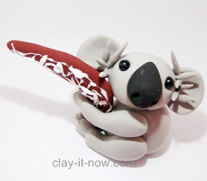 cute koala with boomerang figurine, koala clay