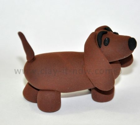 dachshund figurine, short-legged long-bodied dog breed, dachshund