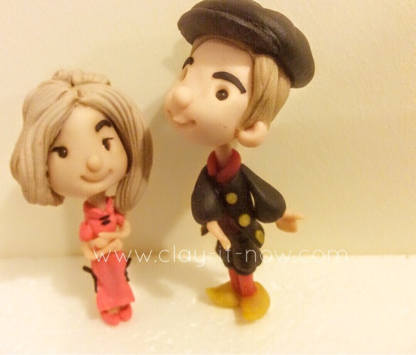 Cute couple figurine wearing Qi Pao and Dutch traditional dress